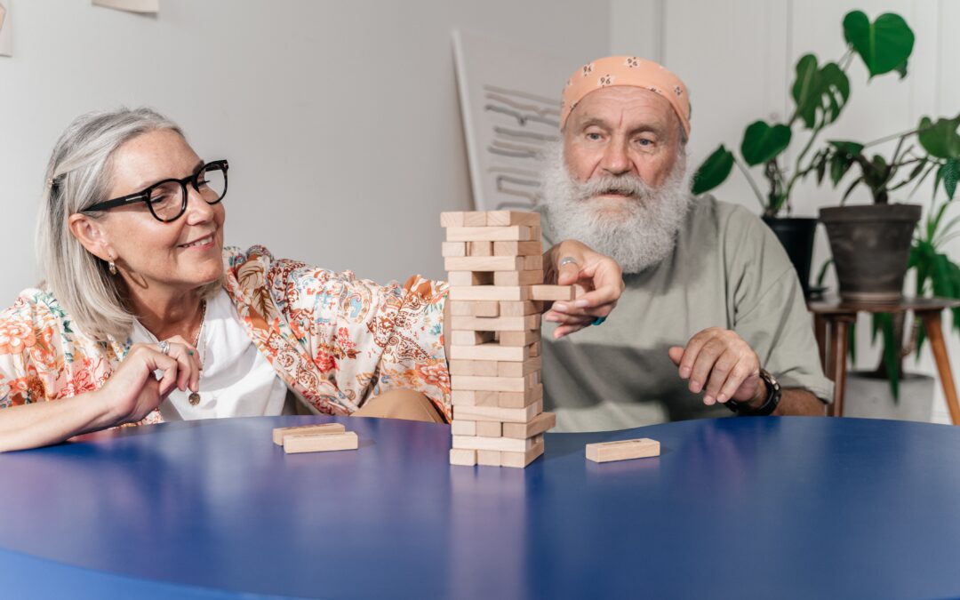 senior couple playing with wooden blocks